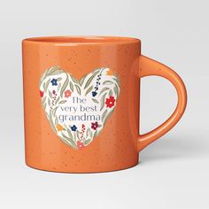 an orange coffee mug with the words'the very best grandma'printed on it