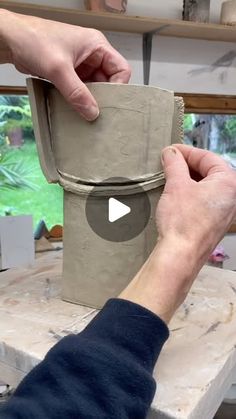 a person is making a vase out of clay with their hands and thumbnails