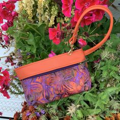 "Delicious Orange Leather combined with a hot,Orange Purple Batik..Those colors together end up looking a lot like Fall in the Finger Lakes! It's a minimalist Handbag,Wristlet, Clutch, Wallet ,or Phone Case. Top zip opens to roomy interior that will fit the largest Phone and a small pocket for your credit cards. AND there's a clip off key ring! Outside features one large zip pocket. 7.5\" wide 4.75\" deep 1.25 bottom" Orange Pouch Wallet For Daily Use, Orange Rectangular Coin Purse For Daily Use, Orange Travel Pouch With Zipper, Orange Pouch Wallet For Everyday Use, Orange Rectangular Bag With Zipper Pouch, Rectangular Orange Bag With Zipper Pouch, Orange Pouch Shoulder Bag With Cell Phone Pocket, Orange Bags With Cell Phone Pocket For Daily Use, Purple Handheld Clutch For Everyday Use