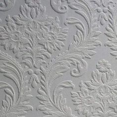 white wallpaper with an intricate design on the back and side of it's surface