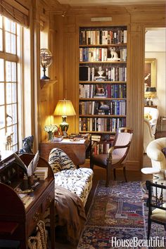 a living room filled with lots of furniture and bookshelves