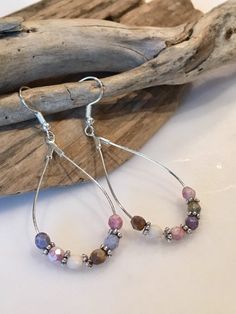 These beautiful earrings have a fun boho style! Made with Silver Teardrop hoop wires with gorgeous 6mm Faceted gemstones and gorgeous silver spacers. The earring itself measures approximately 2 inches in length by one inch wide. The ear wires are lead and nickel free. Colors of pale blues, lavender,pink, grays and cream.. Beautiful statement earrings that can be dressed up or down and worn throughout the year! Your Boho style earrings will come packaged in a pretty gift box, ready for giving or Colored Earrings, Bracelets With Meaning, Boho Style Earrings, Earrings Teardrop, Lavender Pink, Beaded Hoop Earrings, Beaded Hoops, Bead Leather, Pretty Gift