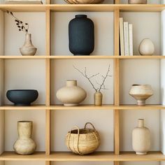 shelves with vases, baskets and books on them