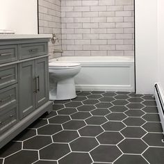 a white toilet sitting next to a bath tub in a bathroom