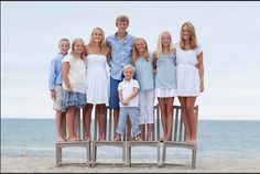 a group of people standing next to each other on a beach