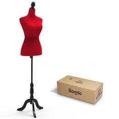 a red mannequin is standing next to a cardboard box on a black stand