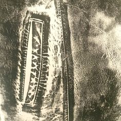 an aerial view of a train track in the middle of some grass and dirt, taken from above