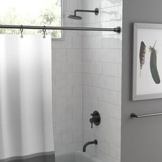 a bathroom with a shower curtain and white tile walls