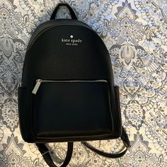 Nwot Kate Spade Black Leila Large Flap Leather Backpack. Never Worn After Taking It Out Of The Package. 13.3”H X 9.4”W X 7.6”D Pebbles Leather, Metal Pinpoint, 2 Way Spade Jacquard, Front Zip, Side Slip Pockets, And Zip Around Elegant Kate Spade Backpack For Errands, Chic Kate Spade Backpack For Errands, Kate Spade Backpack With Removable Pouch, Kate Spade Black Leather Backpack, Kate Spade Satchel Backpack, Kate Spade Black Everyday Backpack, Kate Spade Backpack With Adjustable Strap For Errands, Black Leather Kate Spade Backpack, Kate Spade Elegant Backpack