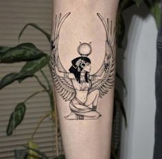 an egyptian tattoo on the leg of a woman with wings and headdress in black ink