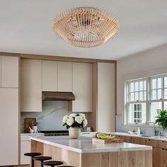 a kitchen with an island and stools in it