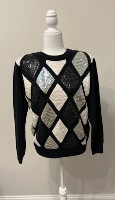 "This sweater is gorgeous!  The sequins just twinkle!  They have an iridescent look.  It's a perfect sweater for dressy occasions or a fun night out.  It's very holiday festive! I love the argyle twist!  It is a size Petite Medium.  Please see measurements below.  The fabric is all acrylic.  Shoulder pads add lift to the shoulders.  It's not incredibly heavy as embellished sweaters often are.  It's comfortable.  It is such a beautiful vintage sweater!  Thanks for looking! Measurements taken layi