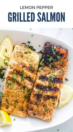 grilled salmon on a white plate with lemons and parsley garnish