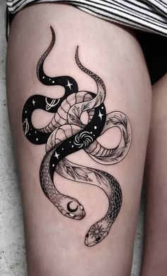 a woman's thigh with a snake tattoo on the side and stars in the middle