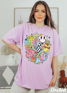 Get ready to rock that casual chic look with our Funny Smiley Face T-shirt ❤️ Get retro with this smiley Graphic Tee! Featuring smiley faces and a nostalgic vibe, this design is perfect for all the cool beach bums out there. Show off your retro style and spread some positive vibes with this fun and funky t-shirt. ❤️ Size up, babe! Go 1-2 sizes bigger for that oversized stunner. Elevate your style, own the spotlight, and unleash your fashion power. It's time to rock the room with your effortlessl Retro T-shirt For Vacation, Funky Tshirts Designs Graphic Tees, Trendy Relaxed Fit T-shirt With Cartoon Print, Pink Cartoon Print Shirt For Summer, Casual Purple T-shirt With Cartoon Print, Oversized Cartoon Print T-shirt For Summer, Oversized Purple T-shirt For Summer, Spring Casual Shirt With Cartoon Print, Casual Relaxed Fit Shirt With Cartoon Print