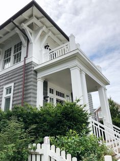 a large house with a white picket fence