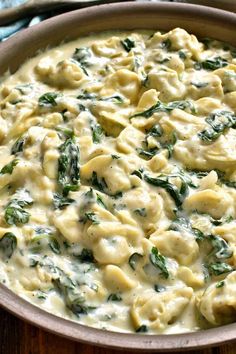 a casserole dish filled with pasta and spinach