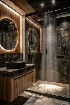 a bathroom with a sink, mirror and shower stall in it's center area