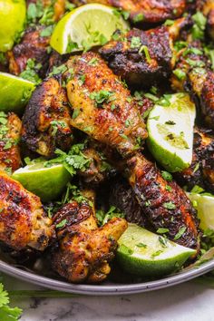 chicken wings with limes and parsley in a bowl