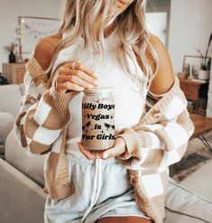 a woman holding a coffee mug with the words billy boy vegas is for girls on it