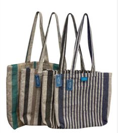 three striped bags are lined up against each other, one has a blue tag on it