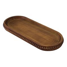 an oval wooden tray with beaded edges