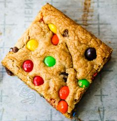 a cookie with m & m's and m's on it sitting on top of a table