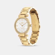 Timeless and elegant the Cary watch is a sophisticated style perfect for day or night. The gold tone bracelet design shimmers with crystals and features a luminous mother-of-pearl dial with our iconic Horse and Carriage motif for a heritage touch. | Coach Cary Watch, 34 Mm - Women's - Gold Elegant Gold-tone Watch With Round Dial, Classic Gold Coach Watch, Classic Gold-tone Watch With Round Dial, Elegant Coach Watch With Polished Finish, Luxury Coach Watches With Polished Finish, Elegant Silver Coach Watch, Coach Timeless Gold Watch, Gold Coach Watch With Metal Dial, Coach Gold Watches With Metal Dial