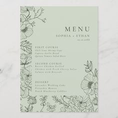 a green menu with flowers on it