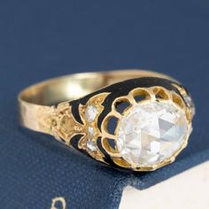 One of the most beautiful rose cut rings we have the pleasure of owning and offering up for sale. An original Vctorian-era jewel (the bottom shank has been replaced at some point in the past). The central rose cut diamond is that oft-requested yet seldom found these days - a true antique rose cut with that high dome and kaleidoscope-like face up. Incredibly white-facing. Set elegantly with prongs and enhanced with black enamel, the ring is regal in all its charm. We can only imagine what the nex Vintage Diamond White Gemstone Ring, Victorian Style Diamond Ring With Diamond Cut, Antique Single Diamond Jewelry In Diamond White, Heirloom Diamond Ring For Ceremonial Occasions, Victorian Style Diamond White Rose Cut Diamond Ring, Victorian Rose Cut Diamond Ceremonial Rings, Victorian Ceremonial Ring With Rose Cut Diamonds, White Antique Ring With Rose Cut Diamonds, Antique White Rings With Rose Cut Diamonds