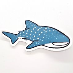 a blue and white sticker with a shark on it's side, in the shape of stars