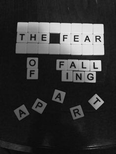 the word fear is spelled by scrabbles on a black surface with white letters