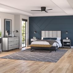 a bedroom with a bed, dressers and mirror in it's center area