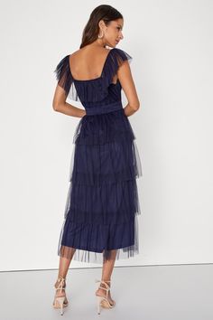 Make an entrance that everyone will love in the Lulus Tier I Come Navy Blue Tulle Square Neck Tiered Midi Dress! Airy tulle shapes this oh-so-sweet dress that features a square neckline, accented by a tying keyhole cutout and a flouncy overlay that flows into fluttery, elasticized straps. Slightly gathered bodice sits atop an elasticized, smocked waist that falls to a tiered skirt that ends at a midi hem. Hidden side zipper/clasp. Fit: This garment fits true to size. Length: Mid-calf length. Siz Blue Sheer Midi Dress For Party, Chic Blue Mesh Dress For Evening, Chic Tulle Midi Dress For Summer, Blue Tiered Tulle Dress, Blue Tiered Party Dress, Tulle Midi Dress For Garden Party, Summer Bridesmaid Tulle Midi Dress, Summer Tiered Tulle Dresses, Summer Cocktail Tulle Midi Dress