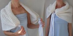 two women wearing white knitted scarves and one is holding an object in her hands