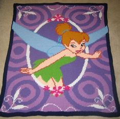 a crocheted blanket with a cartoon tinkerbell on it