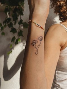 a woman's arm with a small tattoo on the left side of her wrist