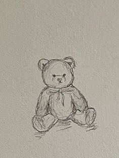 a drawing of a teddy bear sitting on the ground