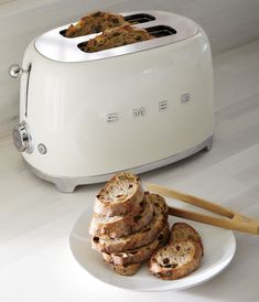 toasters stacked on top of each other with slices of bread in front of them