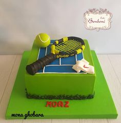 a cake that is decorated to look like a tennis racket and ball on the court