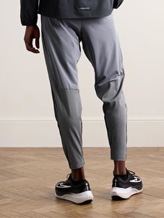 Nike Running’s innovative fabrics are designed with passionate athletes in mind. , These tapered ‘AeroSwift’ track pants are made from breathable, moisture-wicking Dri-FIT ADV , Elasticated drawstring waistband provides a secure and flexible fit , Plenty of pockets for storing your essentials Reflective Stretch Training Bottoms, Sportswear Joggers With Elastic Side Panels, Reflective Sportswear Bottoms For Sports, Sportswear Bottoms With Reflective Details, Athleisure Activewear With Elastic Side Panels And Tapered Leg, Sports Joggers With Elastic Waist And Tapered Leg, Sporty Activewear With Elastic Waistband And Tapered Leg, Functional Gray Running Bottoms, Workout Bottoms With Reflective Details And Stretch