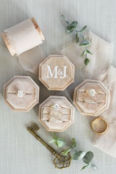 four personalized ring boxes on top of a table next to a roll of toilet paper