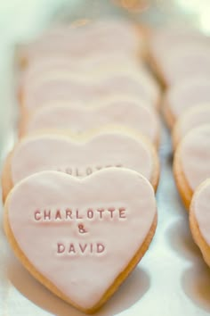 heart shaped cookies with names on them sitting on a table