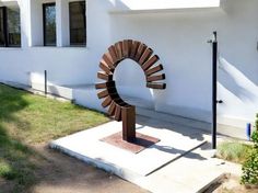 a sculpture in front of a white building