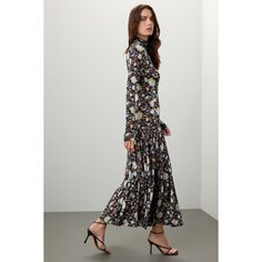 Black floral jersey (91% Rayon, 9% Elastane). Empire. Long sleeves. Turtleneck. Back zipper closure. 51.5" from shoulder to hemline. Imported. Chic Stretch Maxi Dress With Floral Print, Stretch Floral Print Midi Maxi Dress, Elegant Stretch Maxi Dress With Floral Print, Elegant Stretch Floral Print Maxi Dress, Fitted Maxi Floral Dress For Fall, Fitted Floral Maxi Dress For Fall, Fall Evening Maxi Dress With Floral Print, Fitted Floral Print Dress For Fall, Spring Long Sleeve Maxi Dress In Elastane