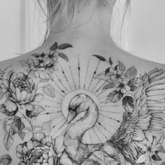 a woman's back with flowers and a bird on it