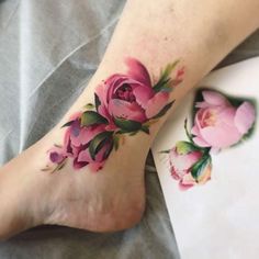 a close up of a person's foot with flowers on it