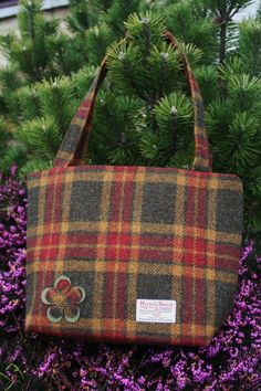 A beautifully spacious Scottish Harris tweed® tote bag with square corners and two shoulder straps which fits comfortably under or over the arm. The size will accommodate an A4 file or iPad. A practical yet stylish size for any woman. Adorned with a felt and tweed applique flower. Tweed is an incredibly durable yet soft fabric, made by crofters to withstand the elements in the North of Scotland. It has a zip across the top to provide security and has a zipped internal pocket too.  Custom request Wool Rectangular Bag For Fall, Rectangular Wool Bag For Fall, Rectangular Tweed Bag For Fall, Rectangular Tweed Bags For Fall, Rectangular Tweed Bags For Daily Use, Rectangular Tweed Bag For Daily Use, Fall Tweed Shoulder Bag, Rectangular Shape, Rectangular Tweed Shoulder Bag For Fall, Fall Rectangular Tweed Shoulder Bag