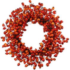 a wreath with red berries hanging from it