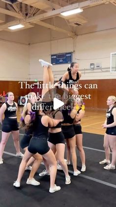 a group of young women standing around each other on top of a basketball court,